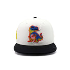 White cap with black brim featuring a colorful embroidered dinosaur design on a white background
