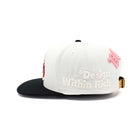 White and black cap with pink accents and 'Design Within Rich' branding on a white background