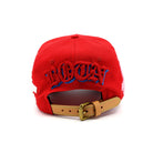 Red cap with blue and white text on a white background