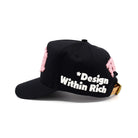 Black cap with pink accents and 'Design Within Rich' text on a white background