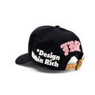 Black cap with 'Design Within Rich' text and pink embroidery on a white background