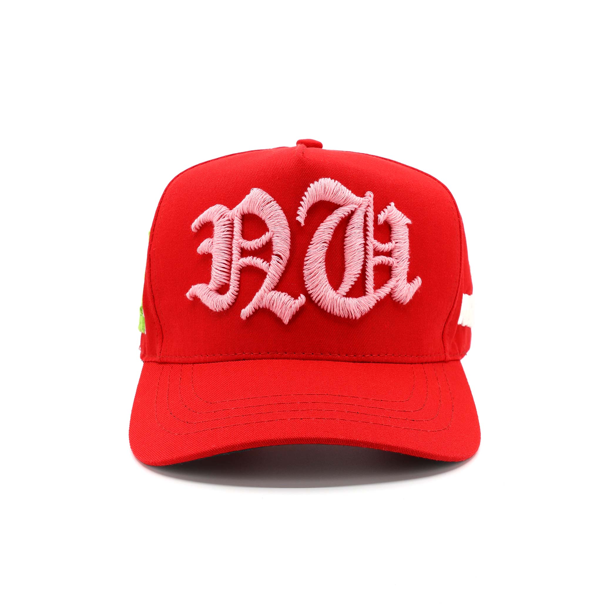 Red cap with pink embroidered letters on a white background