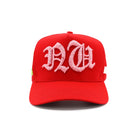 Red cap with pink embroidered letters on a white background
