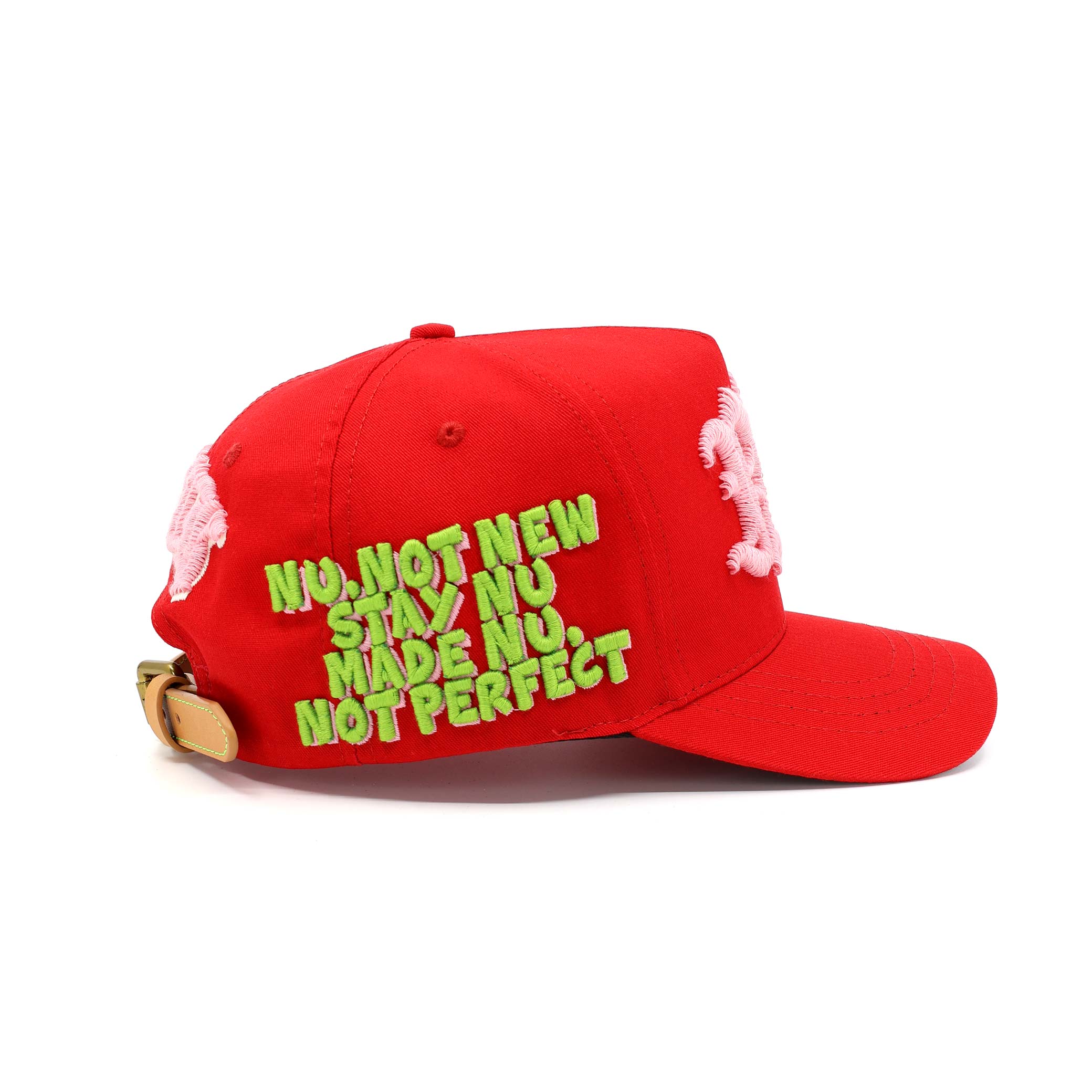 Red cap with green text and pink floral details on a white background