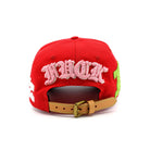 Red cap with pink text and brown buckle on a white background