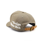 Beige cap with 'Design Within Rich' text on a white background