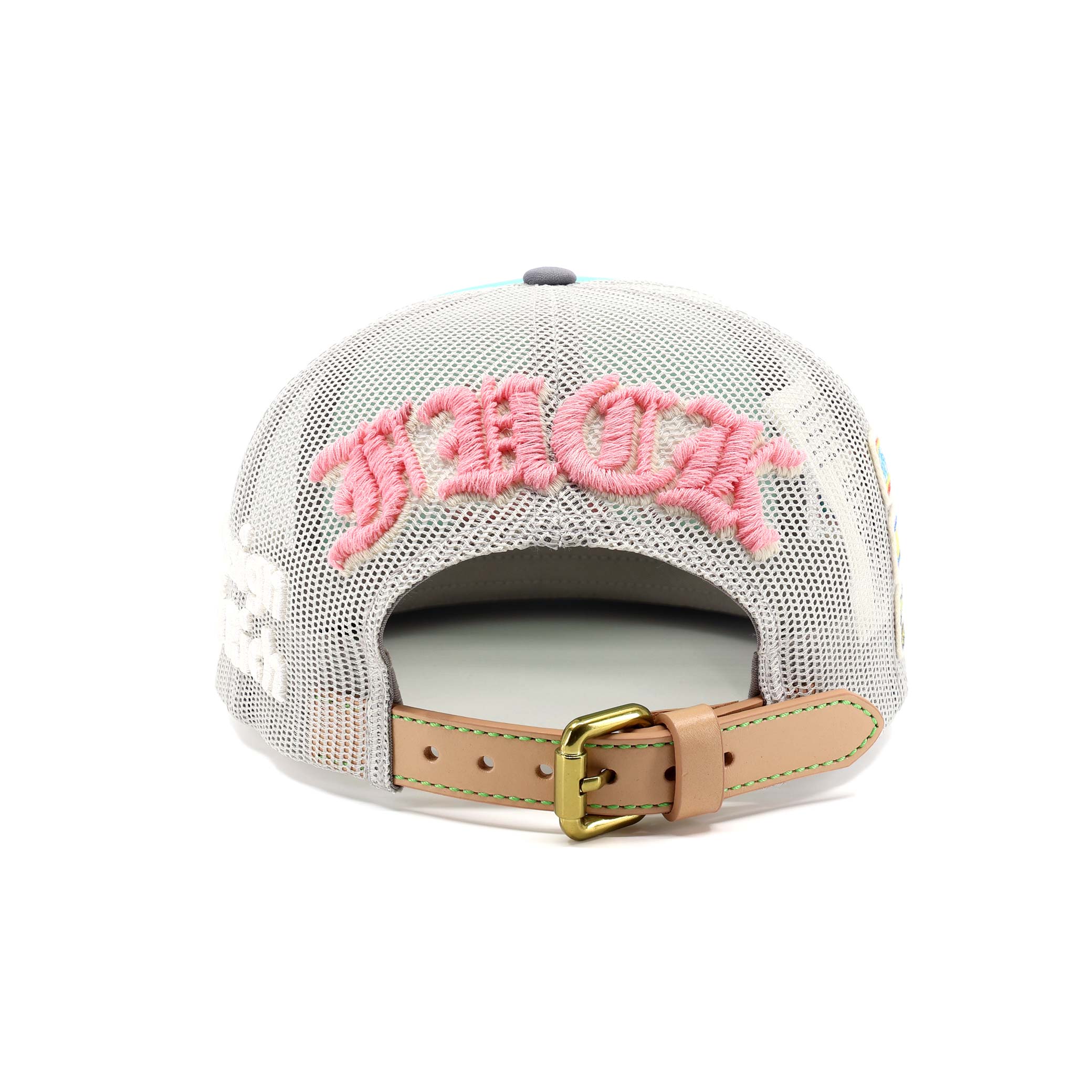 Back view of a cap with pink text and a tan strap on a white background