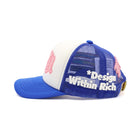 Blue and white cap with pink accents and 'Design Within Rich' text on a white background